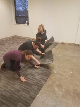 Ladies of TeamPAR install flooring