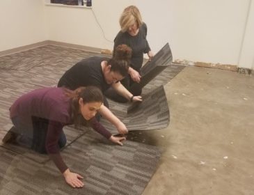Ladies of TeamPAR install flooring